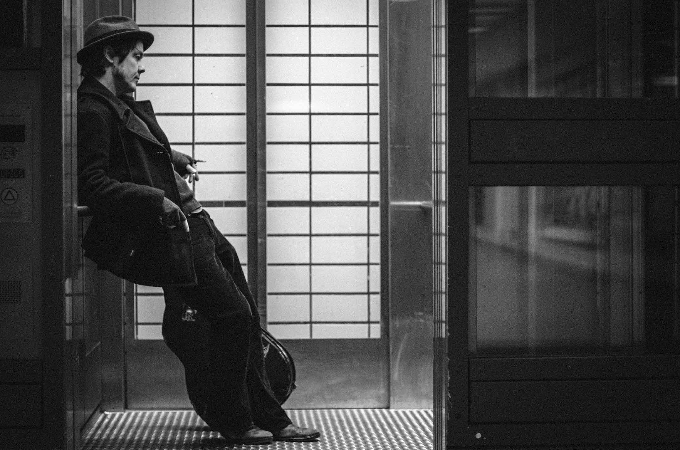 picture of jon leaning on a wall in the subway